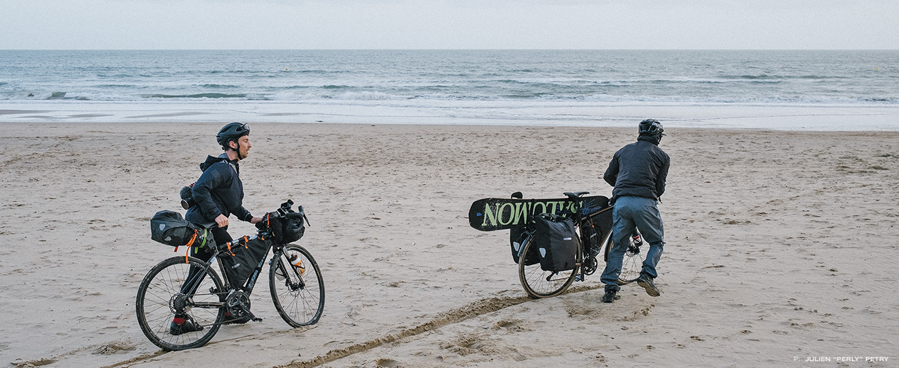 Biking on the coast. Pushing bikes through sand to find surf.